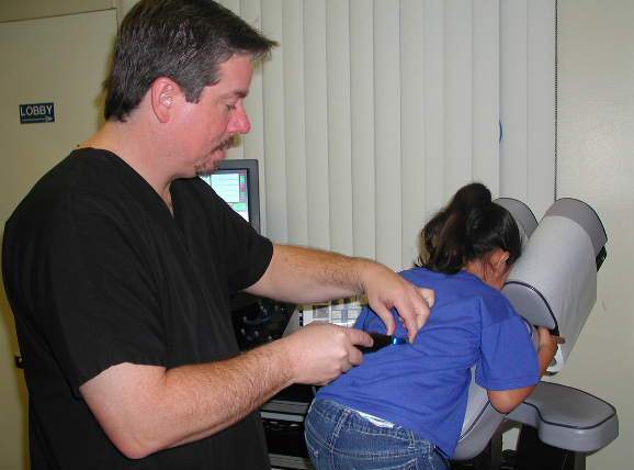 Manual trigger point release therapy applied to a patient's mid-back at Sports & Family Chiropractic